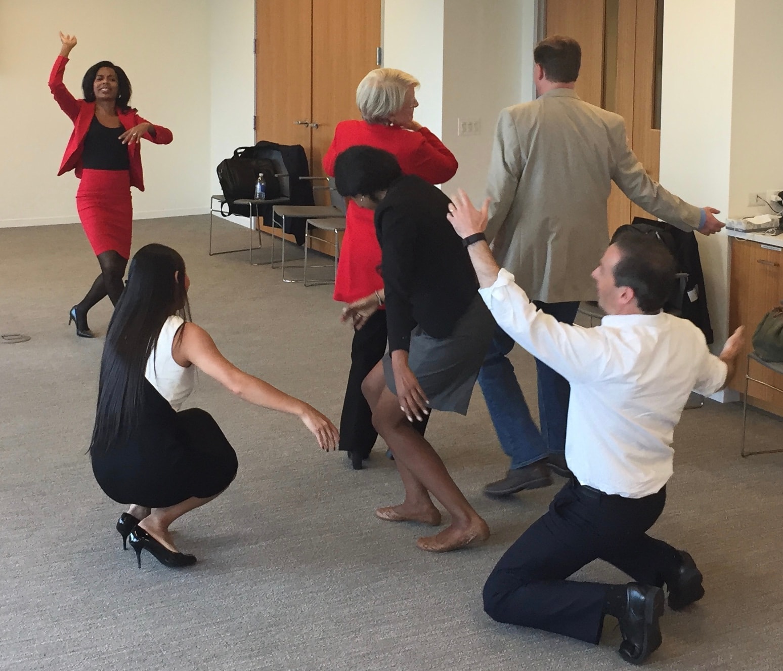 Group of people dancing together indoors